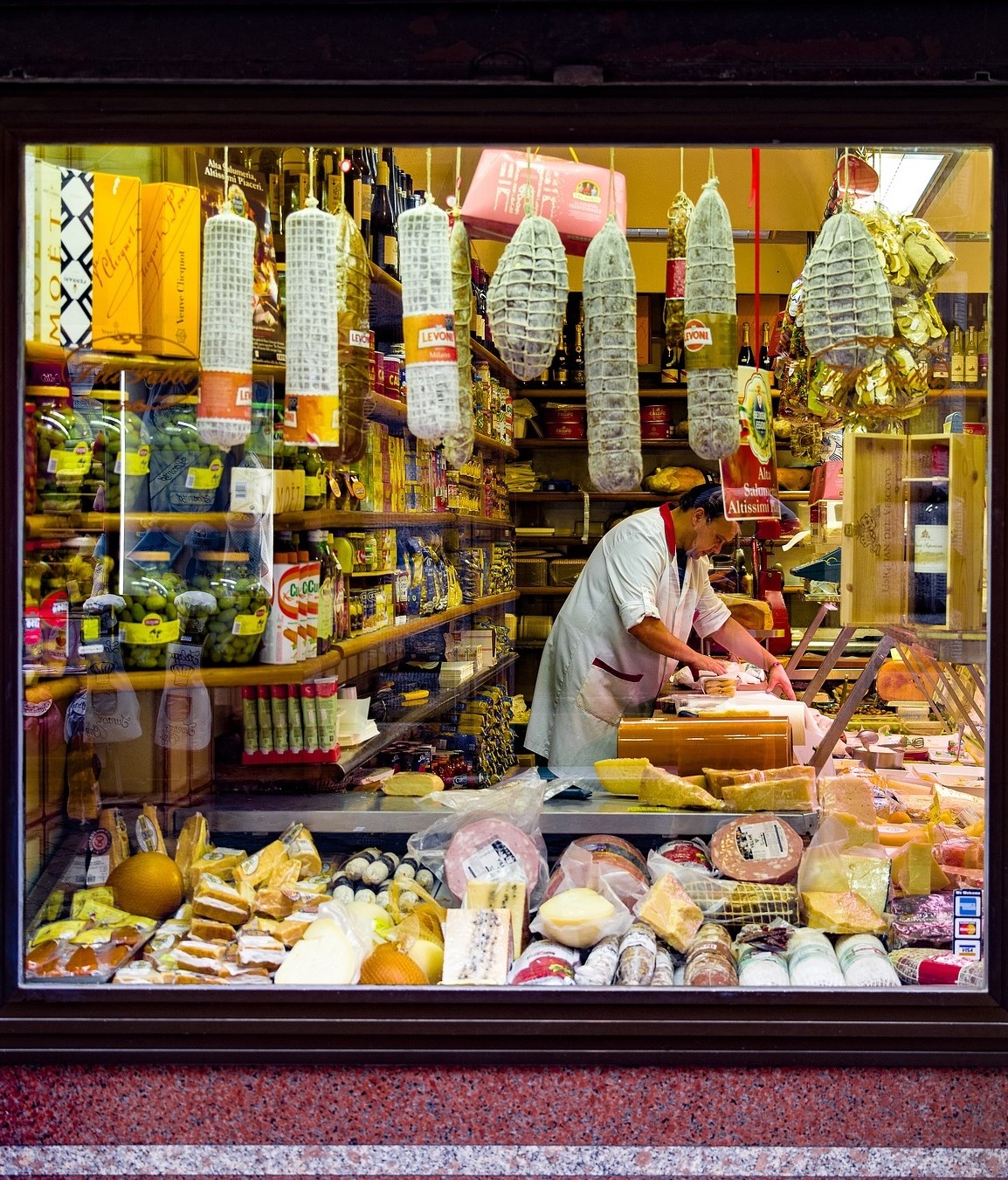 There is a macelleria inside the gates of Sarnano, an Italian butcher shop, the subject of our interest. The couple who run it are old, the store is old. 